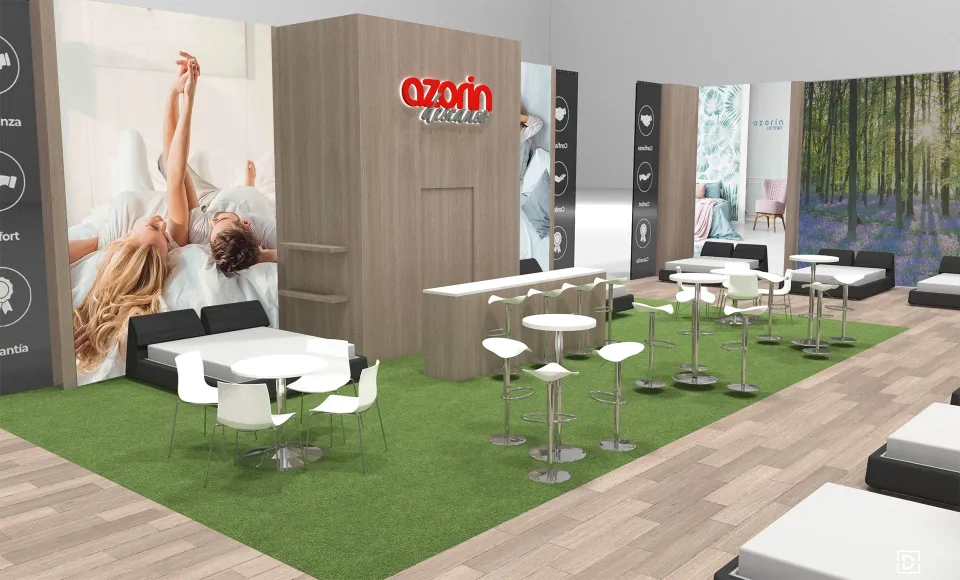 Render 3D del stand de Azorín con césped artificial, mesas altas y un mural de una cama