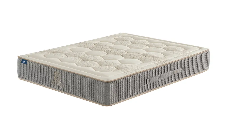 Grey and white quilted mattress shown at an angle on a white background