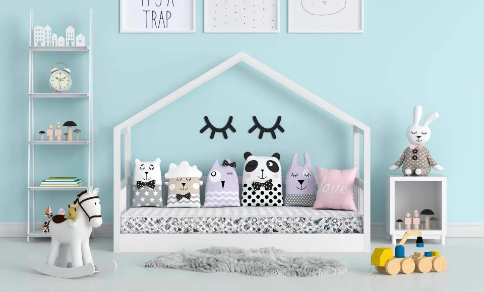 Blue children's bedroom with a house-shaped bed frame, animal cushions and a rocking horse