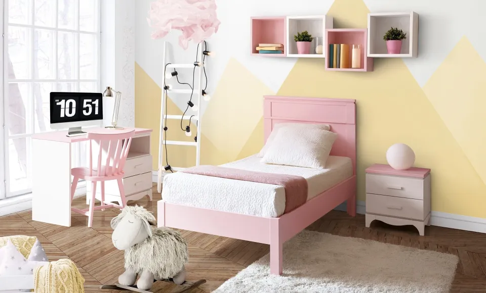 Pink children's bedroom with a matching bed, desk and shelving