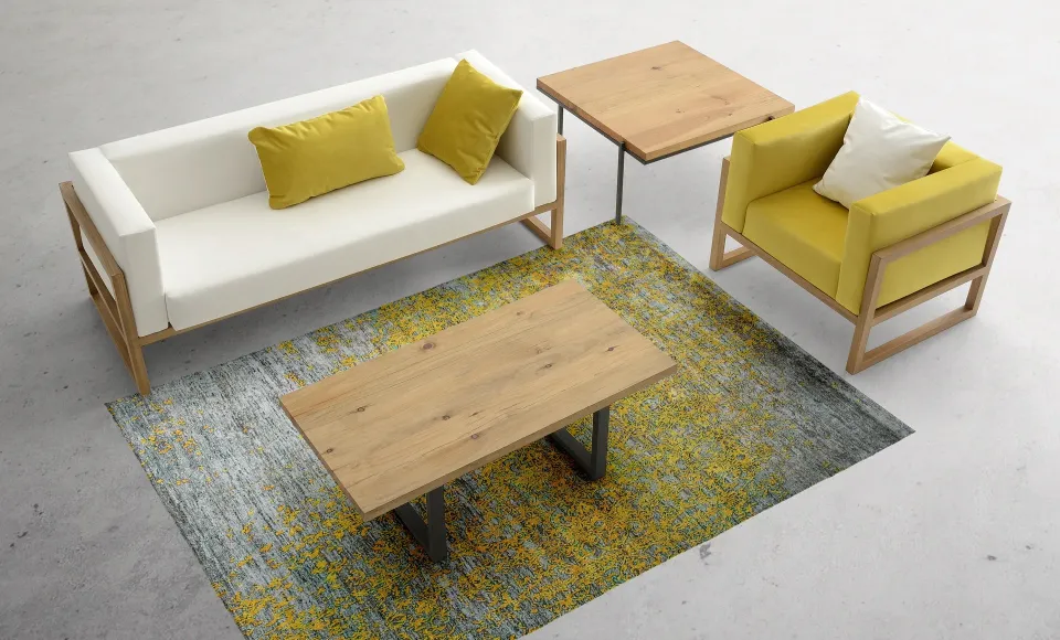 Living room with a white sofa on a wooden frame, and a mustard-yellow armchair and cushions