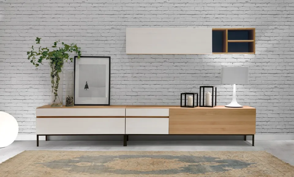 White-and-wood TV unit in front of an exposed brick wall