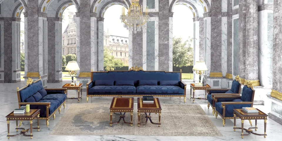 Classical-style hall with marble columns, a chandelier and Koher's blue sofas