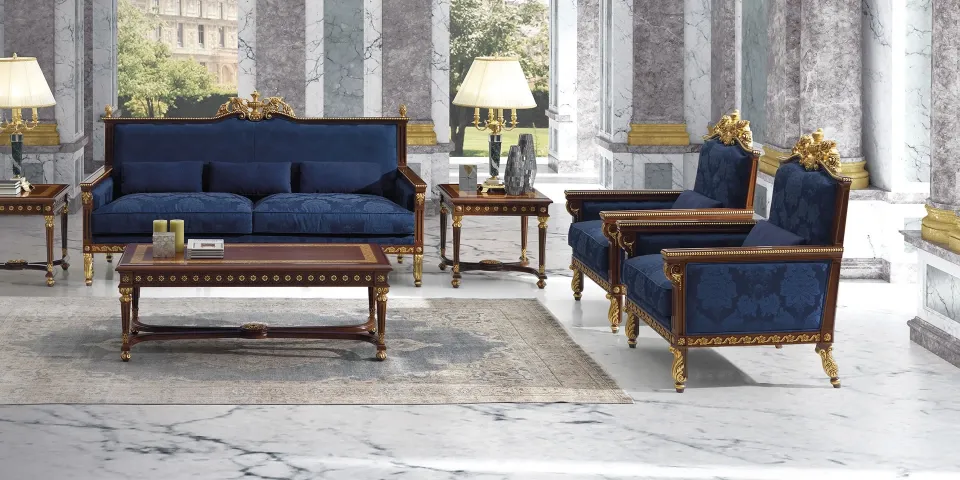 Classical living room with Koher's blue sofa and armchairs, a carved coffee table and columns