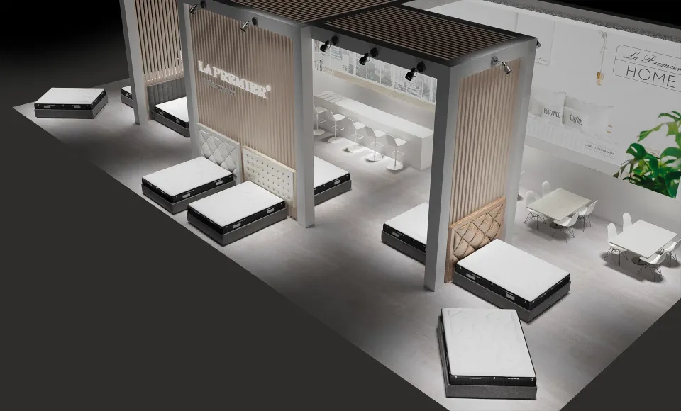 Vista aérea del render del stand con el rótulo «La Premier» y una fila de colchones en el suelo