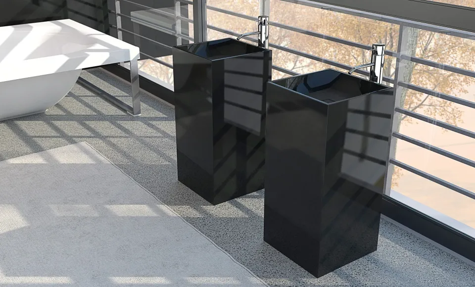 Dos lavabos de pie en negro junto a una terraza acristalada con vistas a los árboles