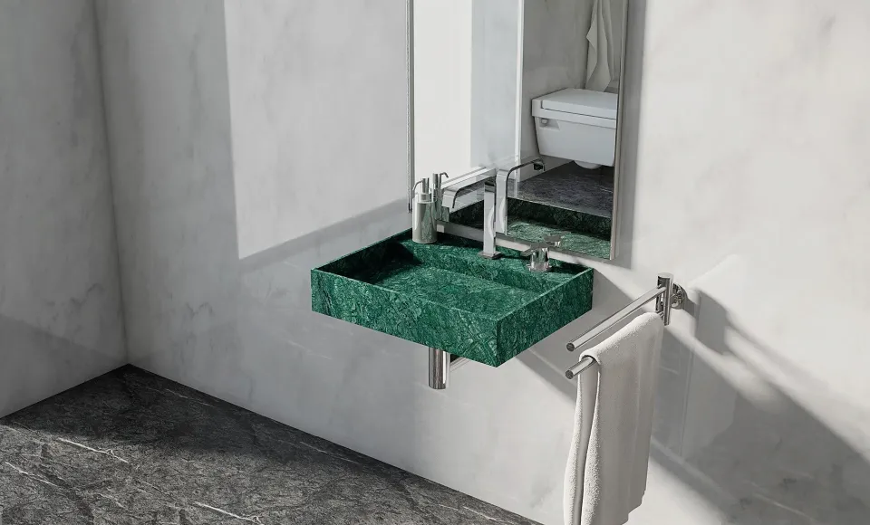 Lavabo de mármol verde suspendido bajo un espejo, con toallero junto a la bañera