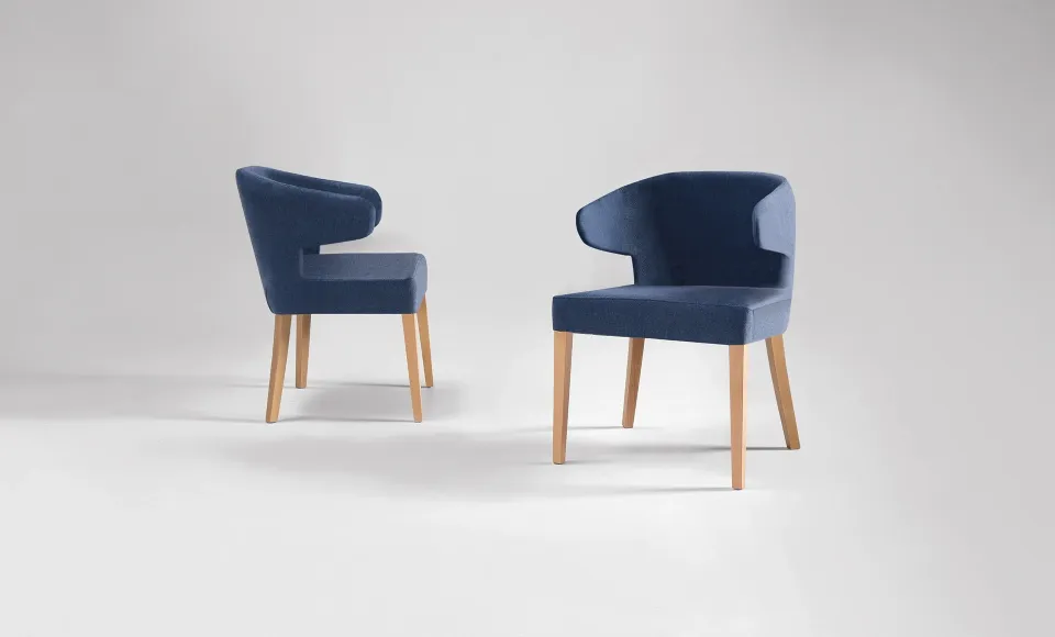 Two navy-blue upholstered armchairs on wooden legs, shown from two angles