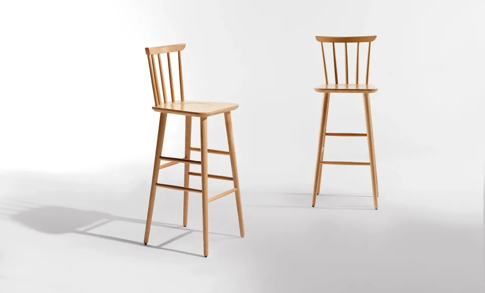 Two tall solid-wood bar stools with spindle backs, shown from different angles