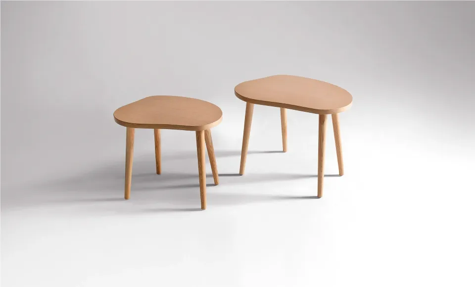 Two organically shaped wooden side tables of different sizes