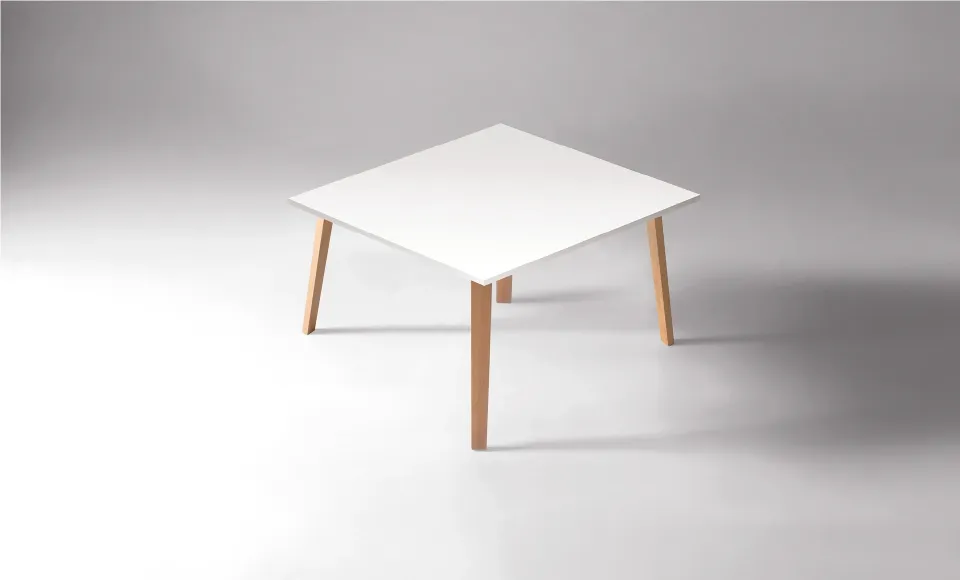 Square table with a white top and wooden legs, photographed against a light grey background